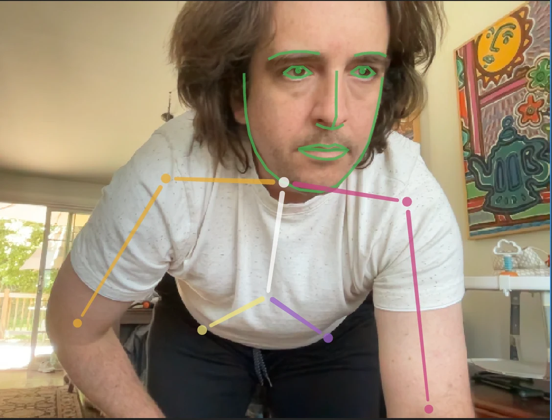The webcam view in Character Animator — face mesh and body tracking on my own face and arms, driving the devil live
