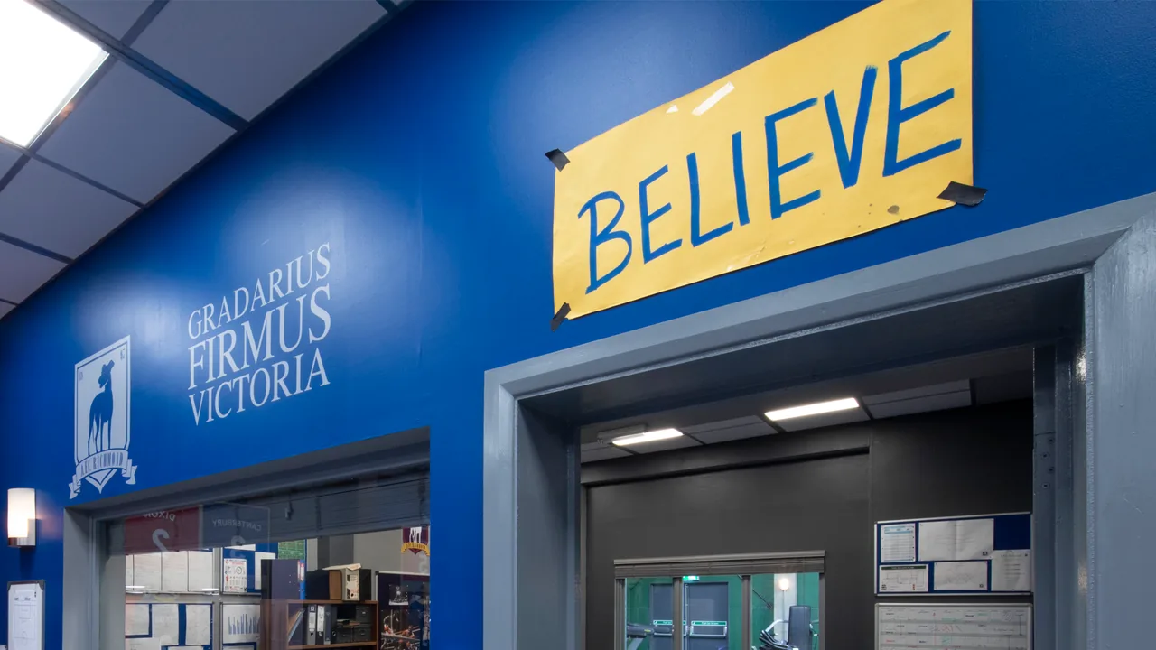 The Believe sign above the locker room door